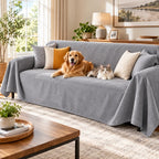 Gray waterproof dog couch cover draped over a three-seat sofa with a golden retriever and cat relaxing in a modern living room.