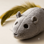 Close-up of plush mouse cat toy face and feathered tail detail