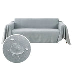 Gray waterproof dog couch cover draped over a three-seat sofa