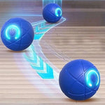 Dog playing with a blue vibrating ball on a wooden floor. - Automatic Rolling Ball Dog Toy