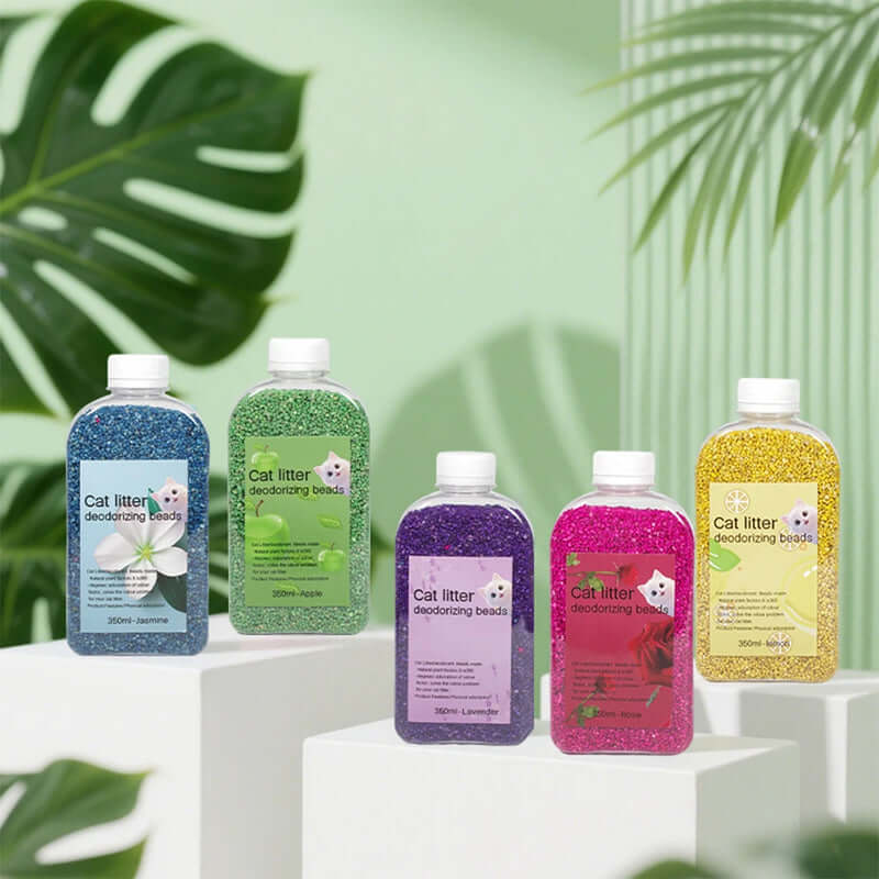 Five bottles of cat litter deodorizing beads in different colors with a green leafy background.- AZPaws
