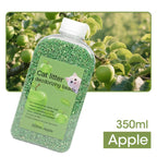 Green cat litter deodorizing beads in a bottle with an apple tree -background -AZPaws